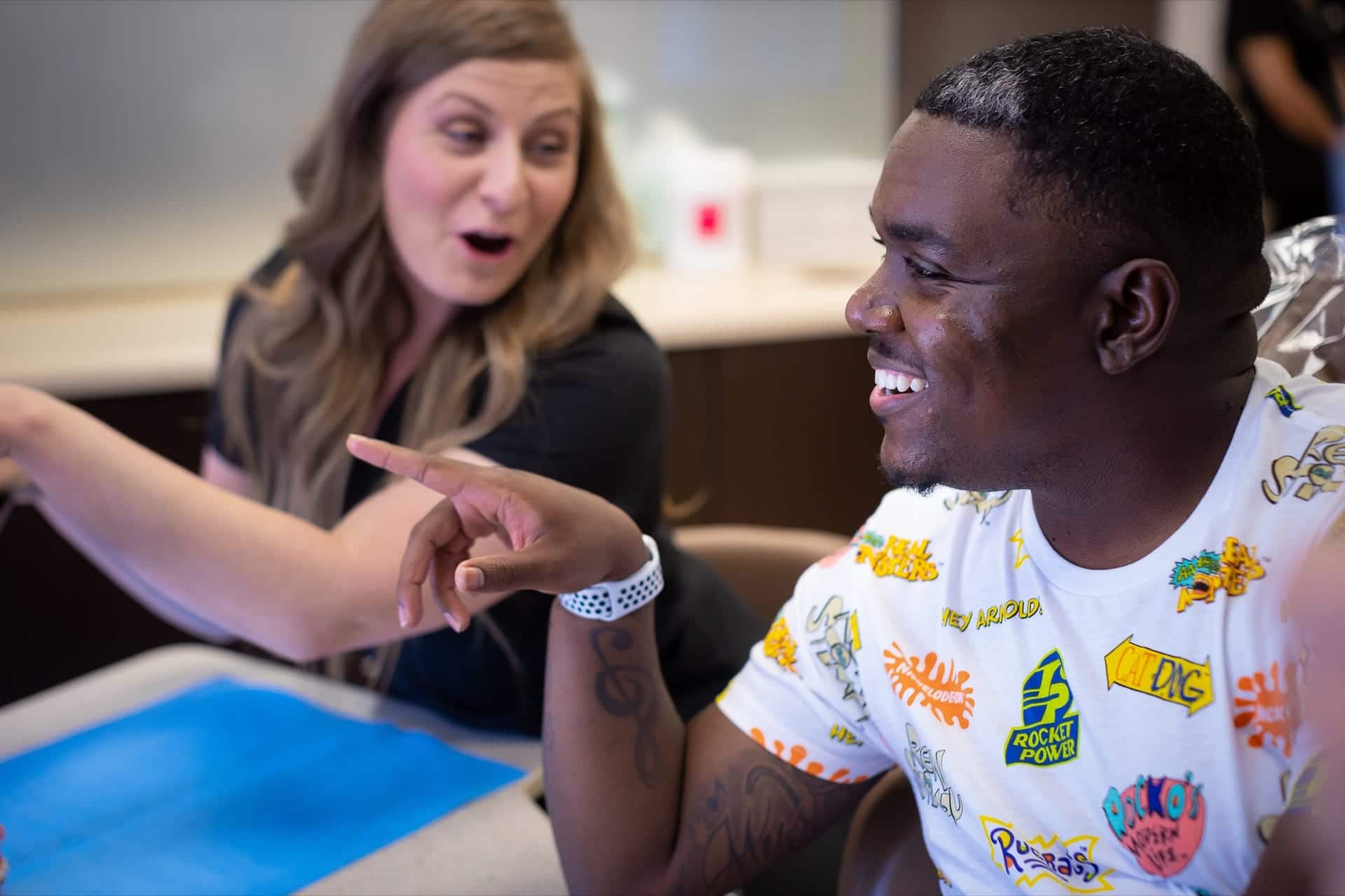 Man looking at braces with his orthodontist