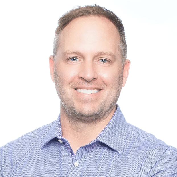 Illinois orthodontist Dr. Bicknell smiling in  a blue patterned button up shirt