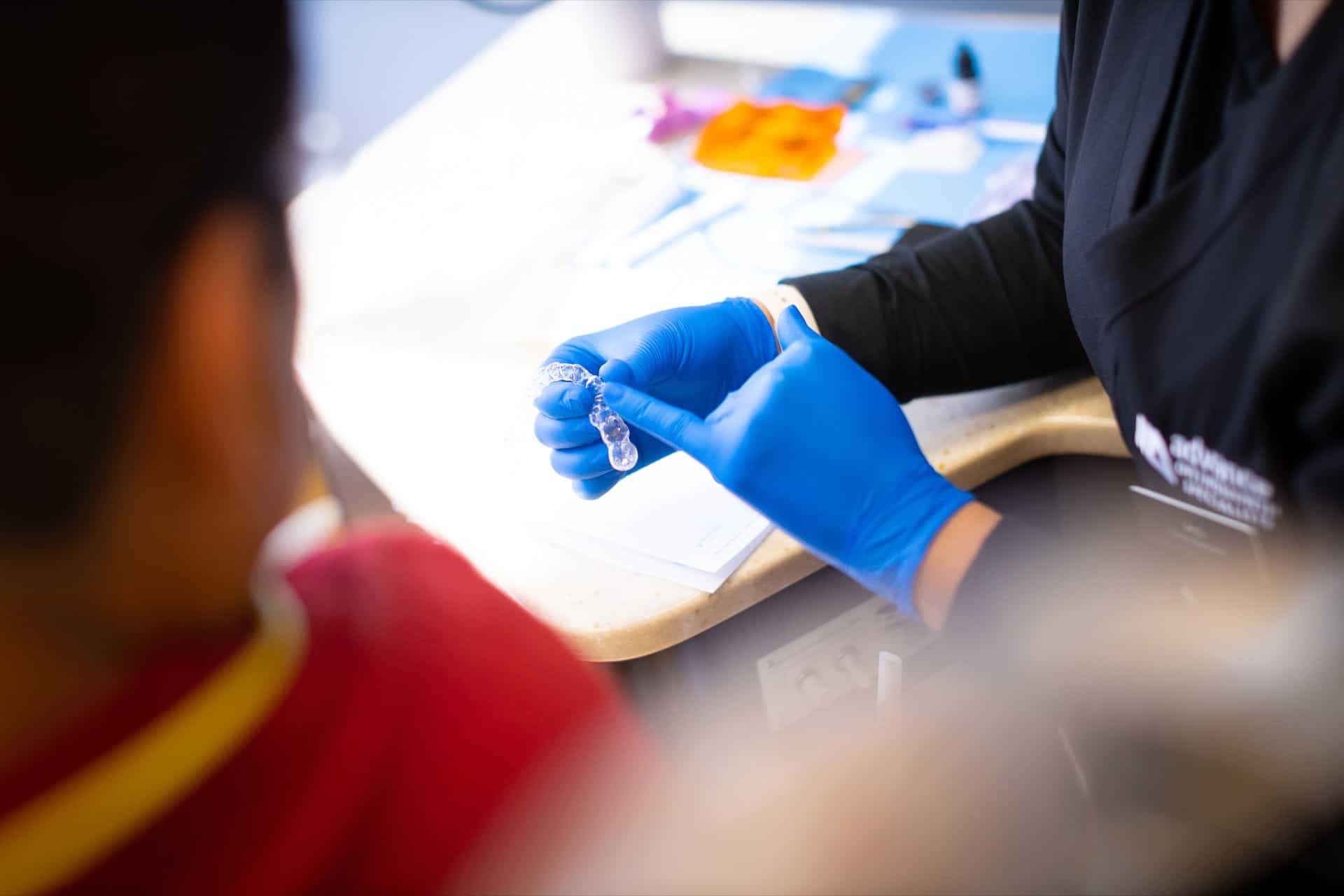 Dr. Bond showing a patient a clear aligner