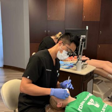 Dr. Ha providing dental care to a patient.