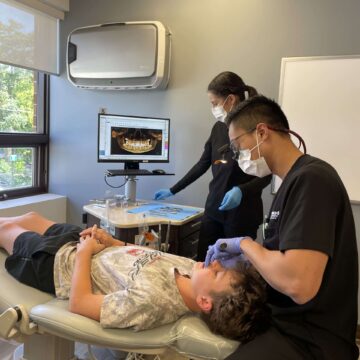Dr. Ha providing dental care to a patient.