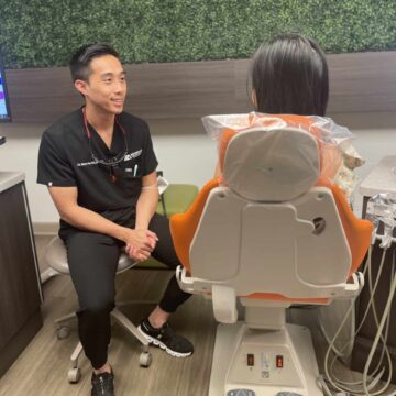 Dr. Ha sits in front of a patient he is consulting with