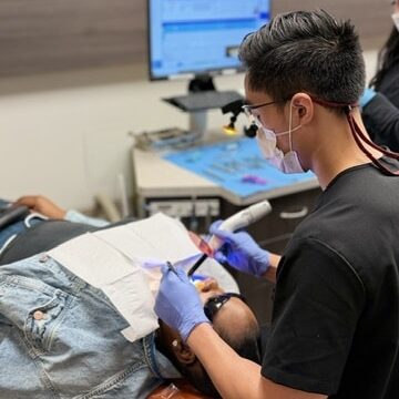 Dr. Ha providing dental care to a patient.